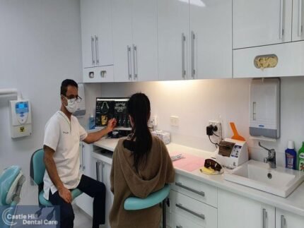 Castle Hill Dentist - Dentist Dr. Jaafar using 3D X-ray to explain treatment options to a female patient.