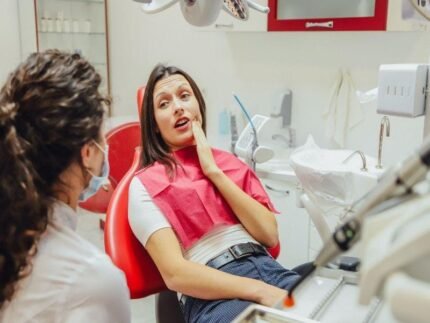 Dentist Castle Hill - Picture of a young girl experiencing tooth ache sitting on the dental chair.